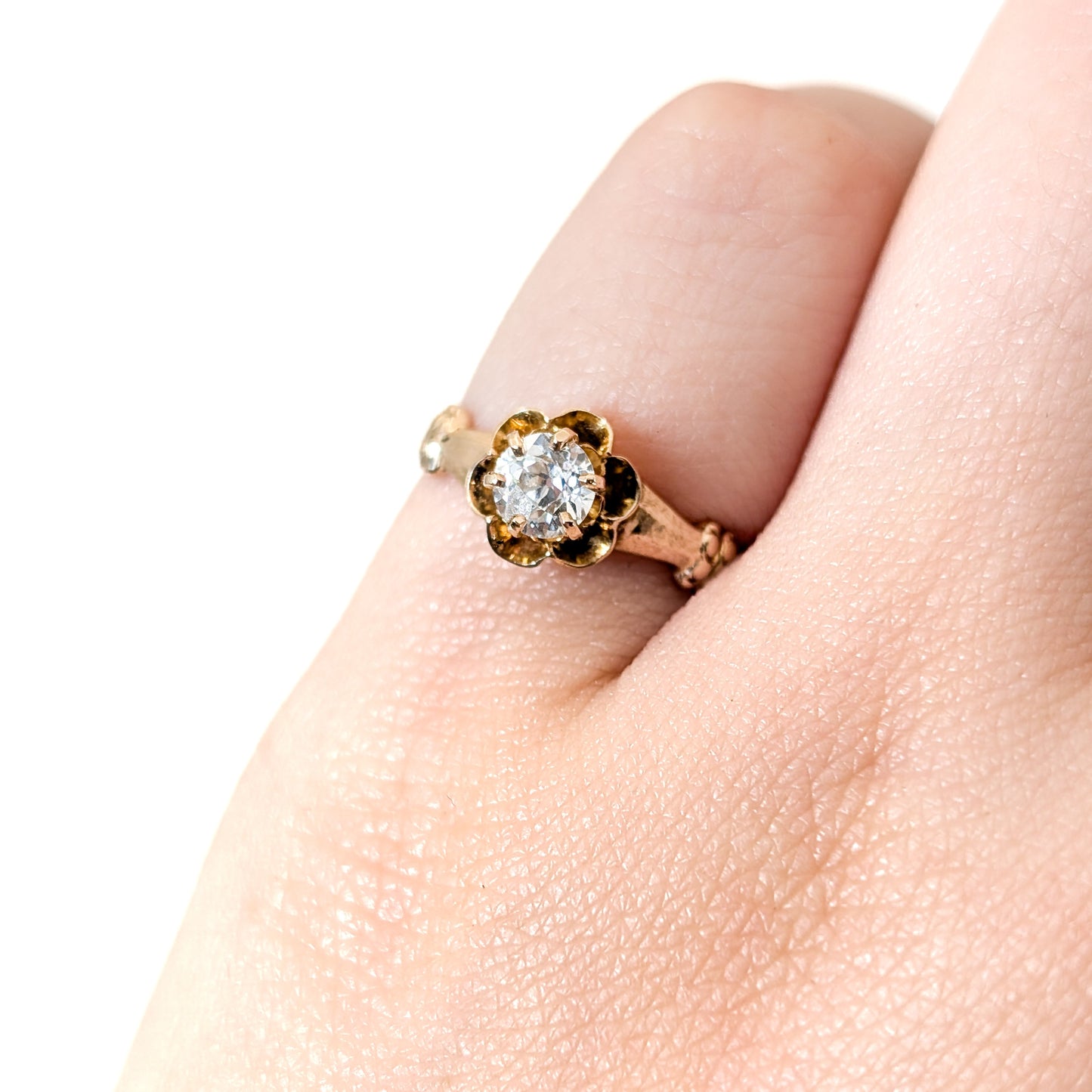 10k Gold ring with a diamond on a white background