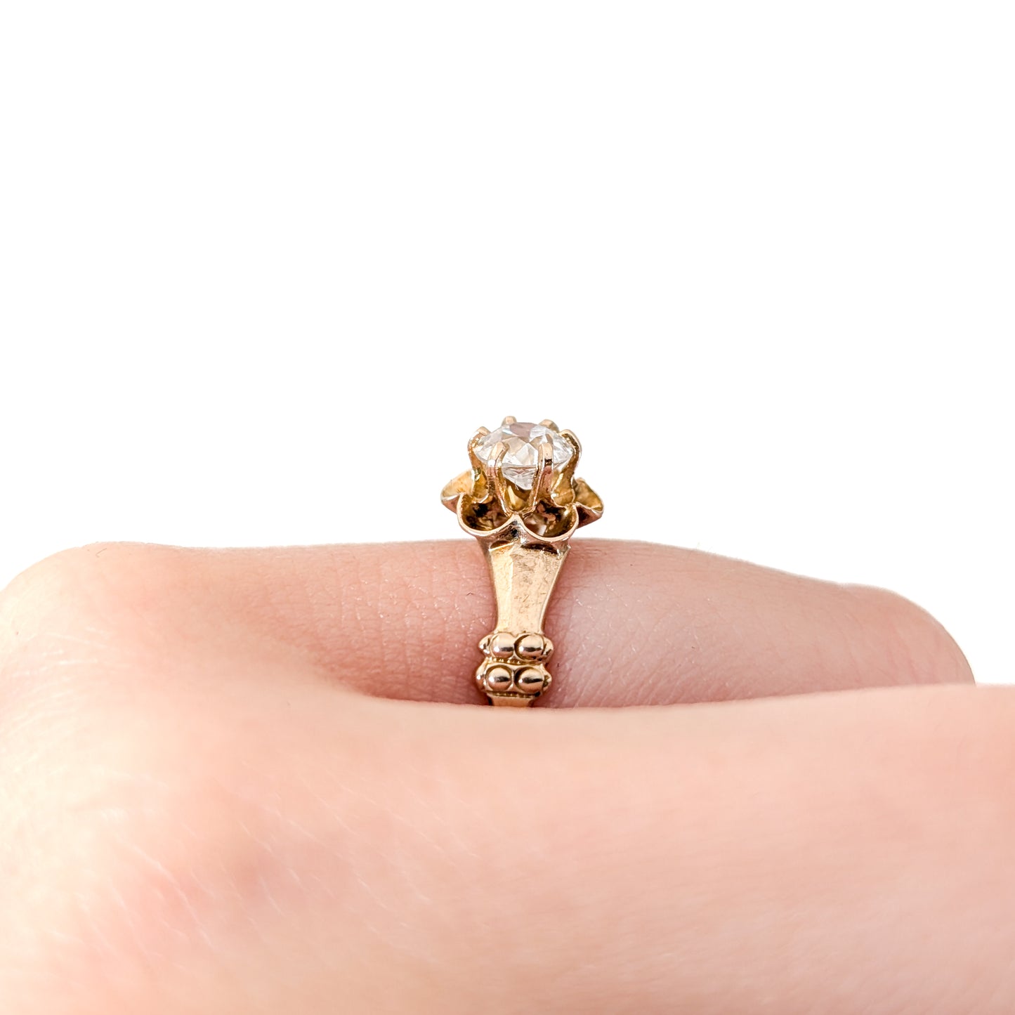 10k Gold ring with a diamond on a white background
