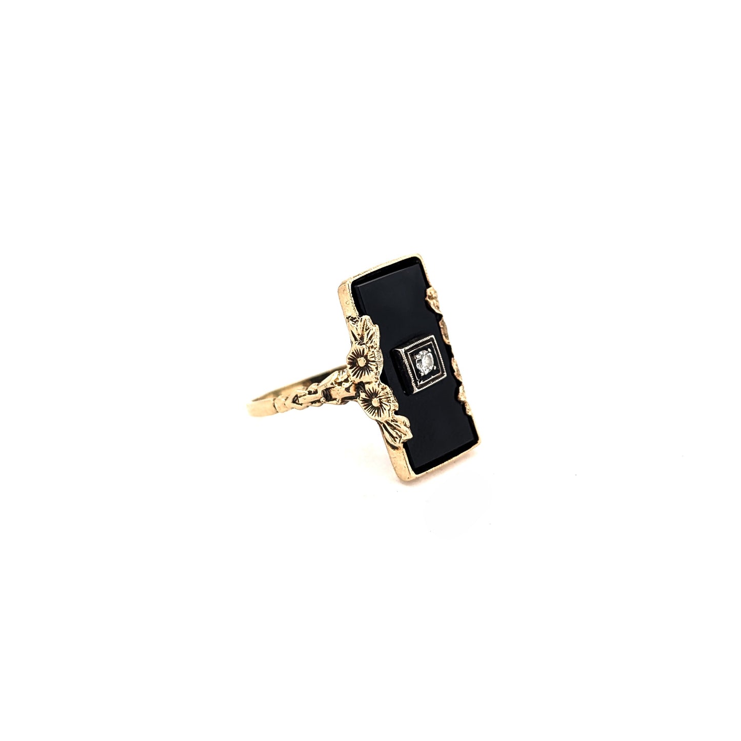 10K Gold Onyx ring with a central diamond on a white background
