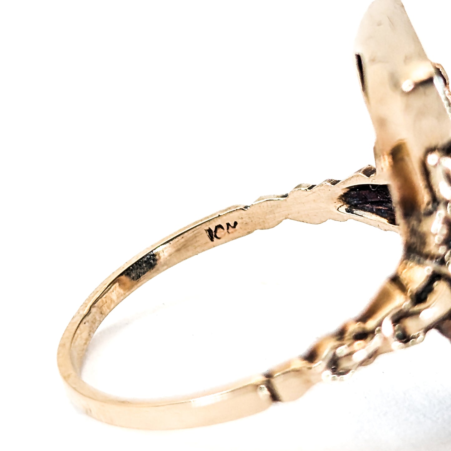 10K Gold Onyx ring with a central diamond on a white background