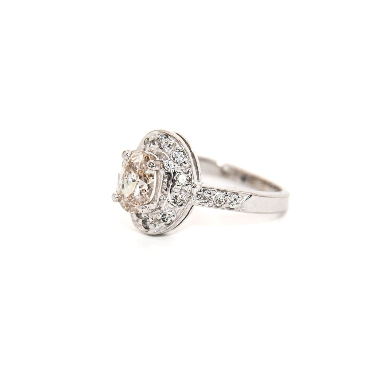 A 14K white gold diamond engagement solitaire ring with a central diamond surrounded by a halo of smaller diamonds, displayed against a white background.