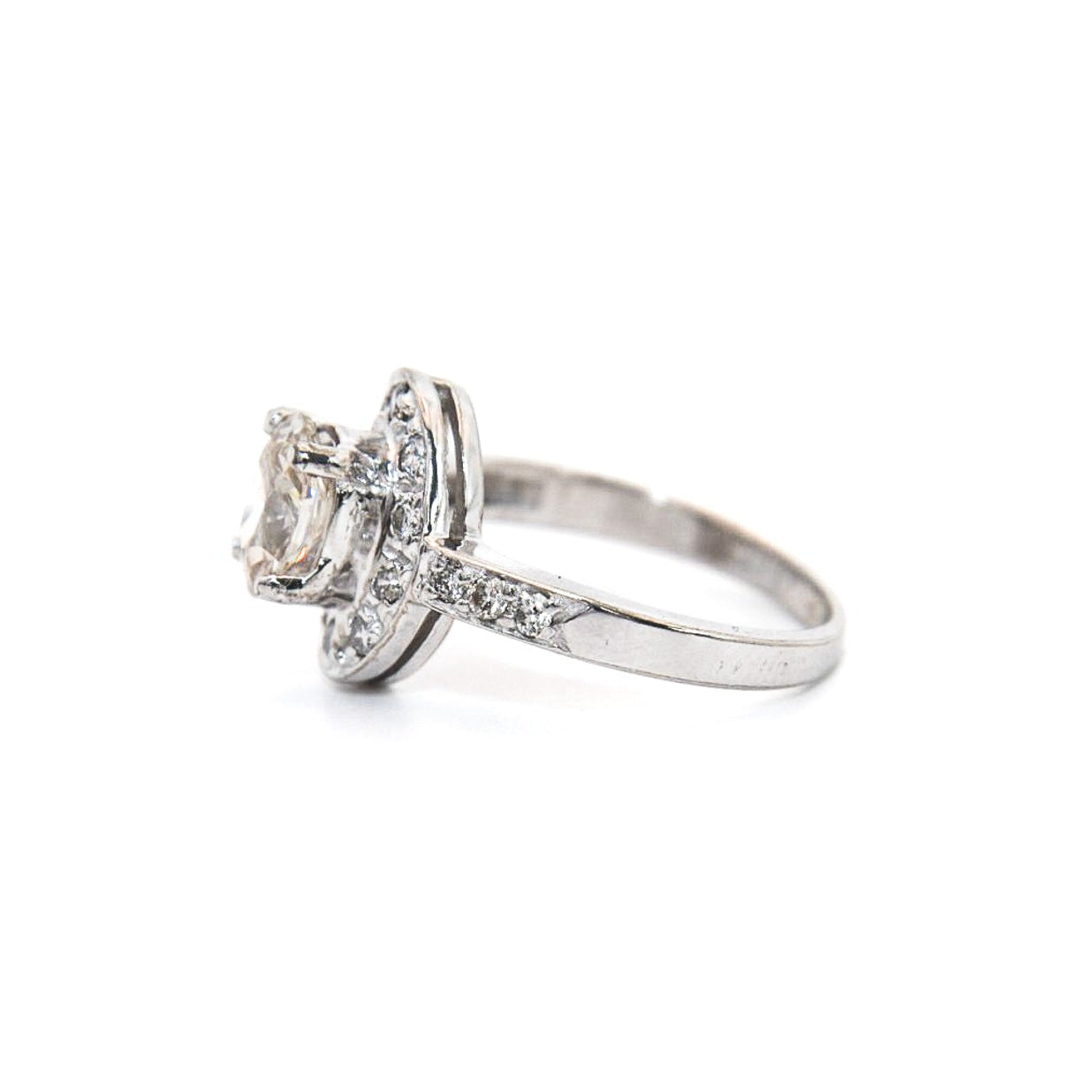 A 14K white gold diamond engagement solitaire ring with a central diamond surrounded by a halo of smaller diamonds, displayed against a white background.