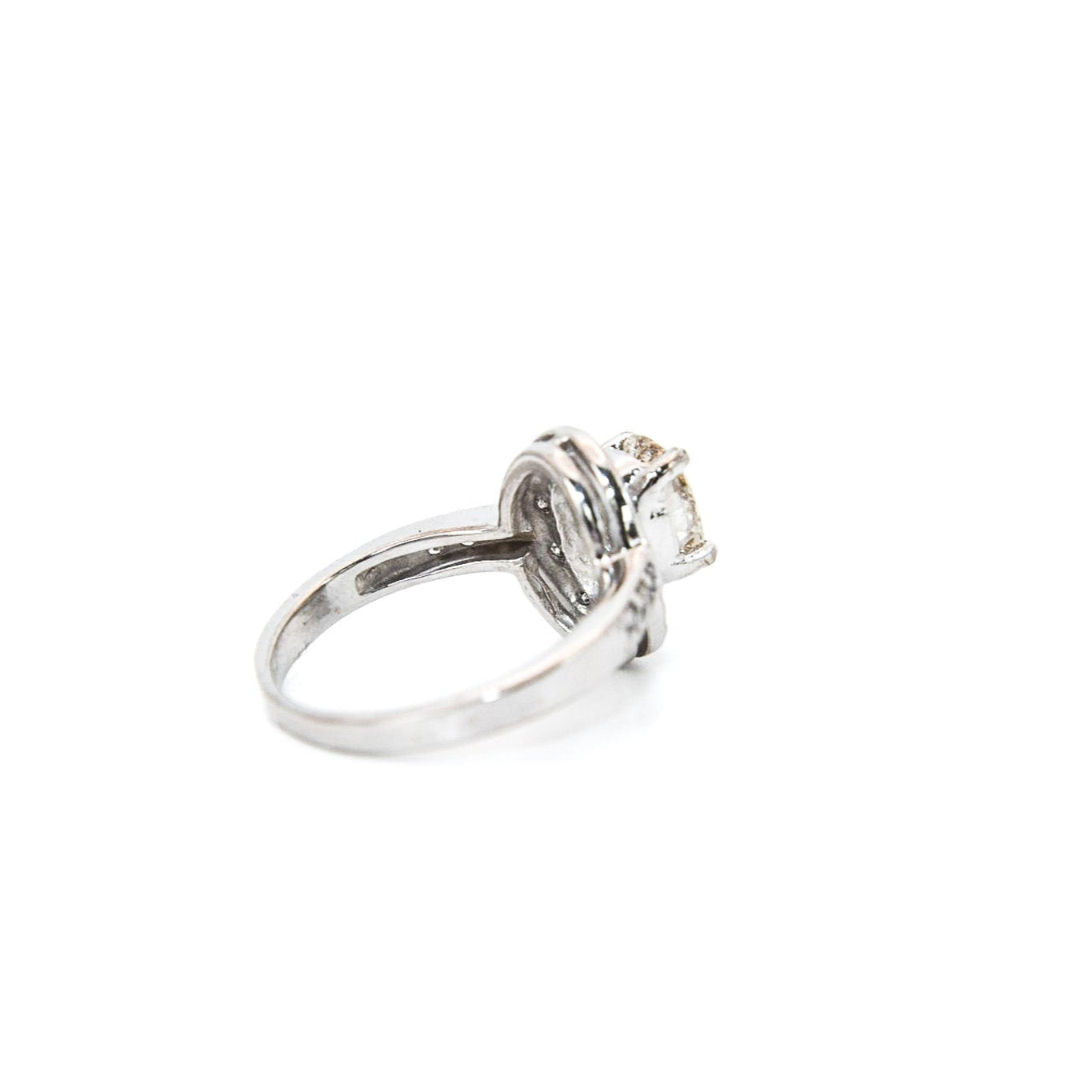 A 14K white gold diamond engagement solitaire ring with a central diamond surrounded by a halo of smaller diamonds, displayed against a white background.
