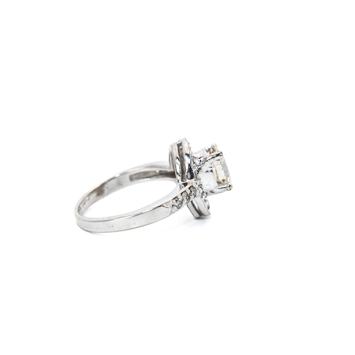 A 14K white gold diamond engagement solitaire ring with a central diamond surrounded by a halo of smaller diamonds, displayed against a white background.
