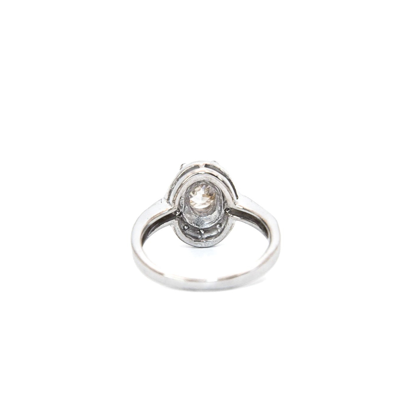 A 14K white gold diamond engagement solitaire ring with a central diamond surrounded by a halo of smaller diamonds, displayed against a white background.