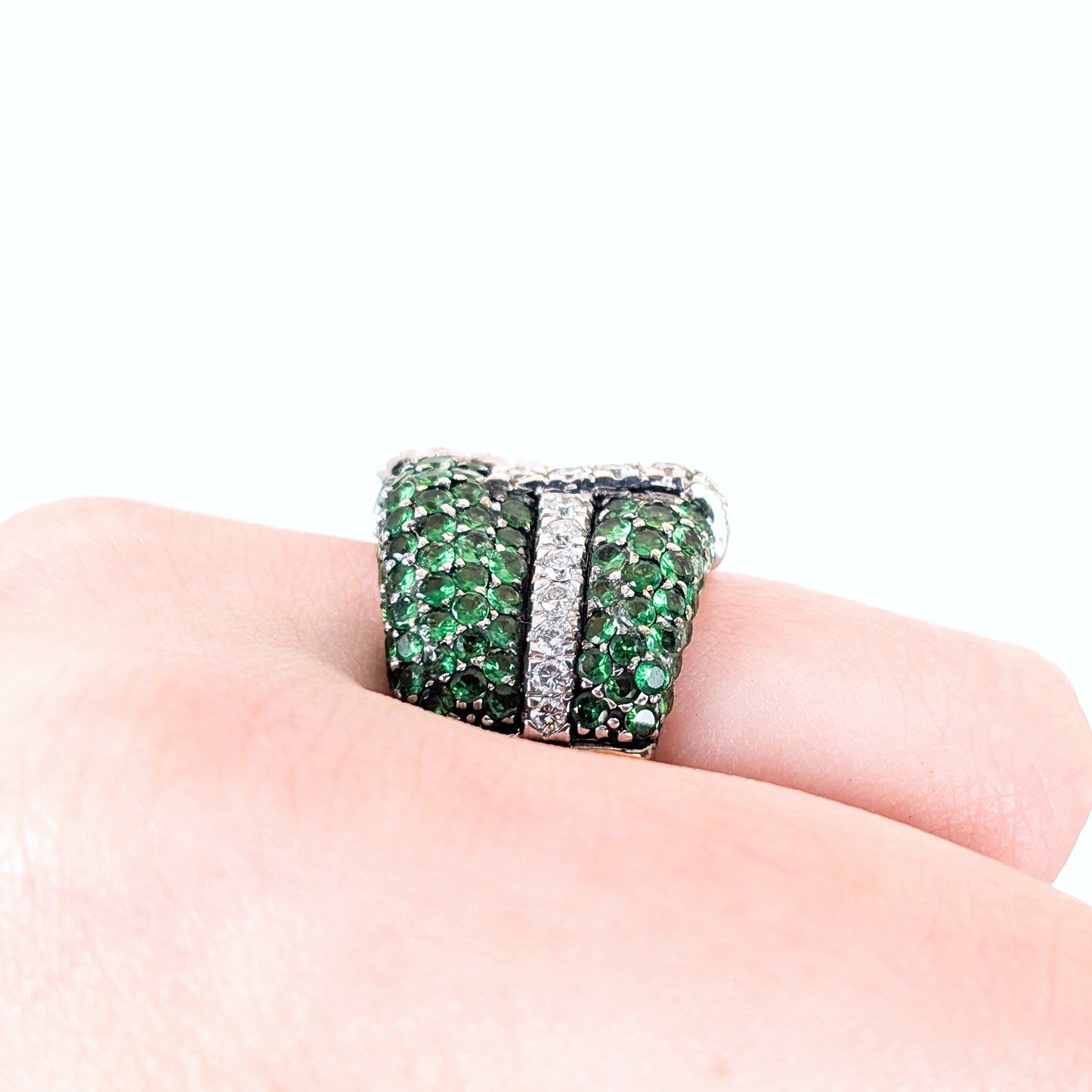 LeVian 14K White Gold Tsavorite Garnet & Diamond Wide Band Ring on a hand against a white background