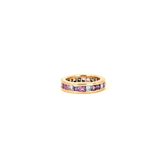 14k gold eternity band with pink sapphires and diamonds on a white background