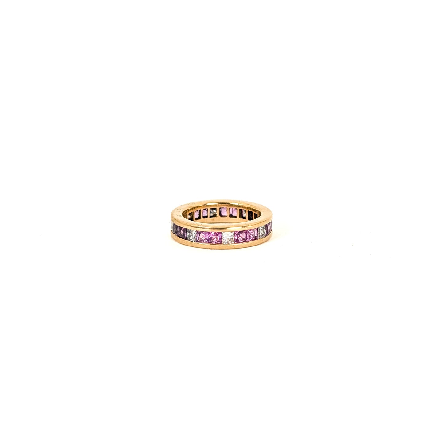14k gold eternity band with pink sapphires and diamonds on a white background