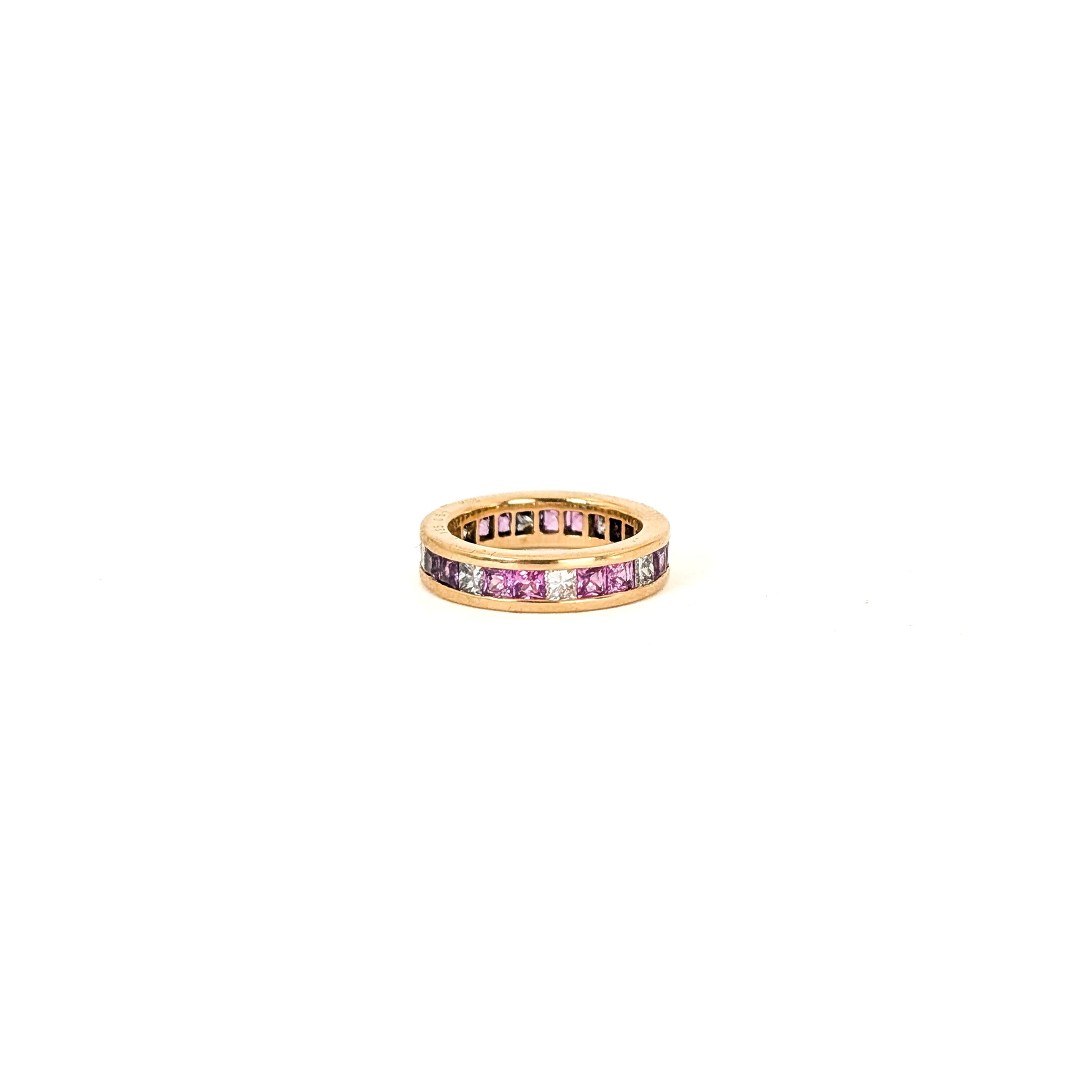 14k gold eternity band with pink sapphires and diamonds on a white background