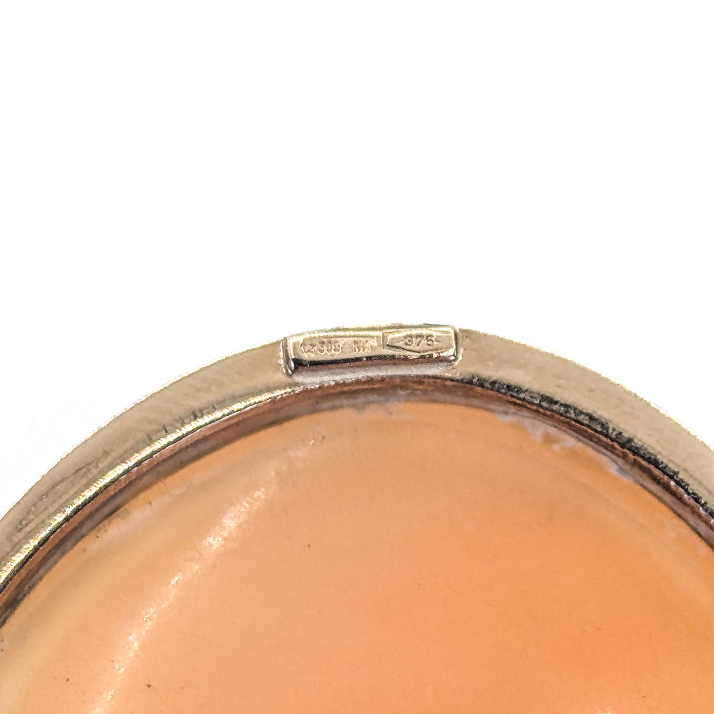 9k gold cameo brooch with a classical design on a white background