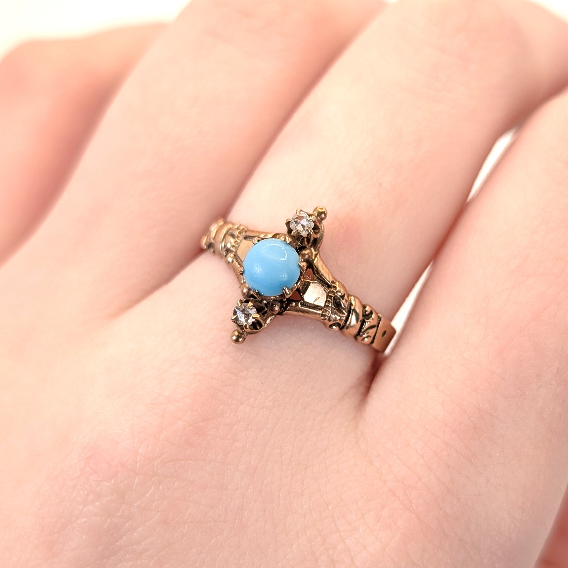 10k Vintage ring with turquoise stone and 2 rose cut diamonds on a hand