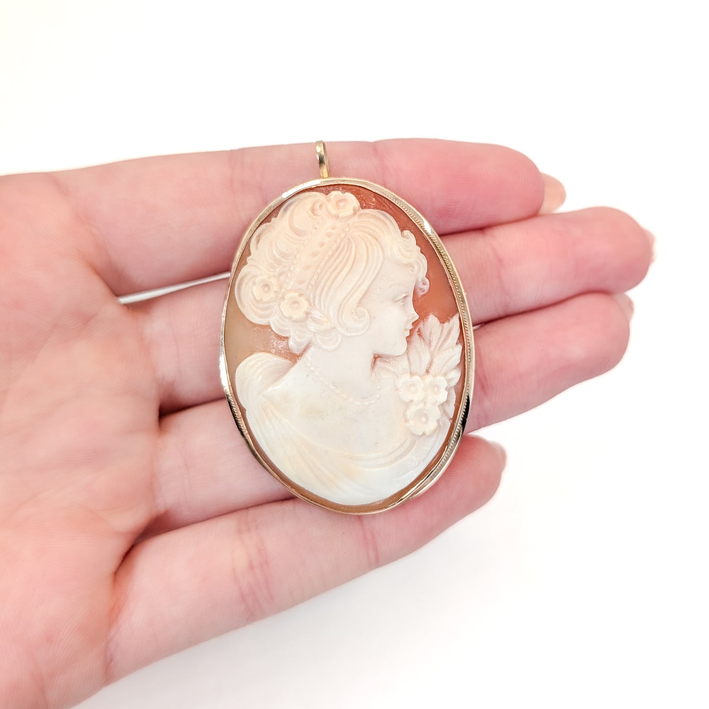 9k gold cameo brooch with a classical design on a white background