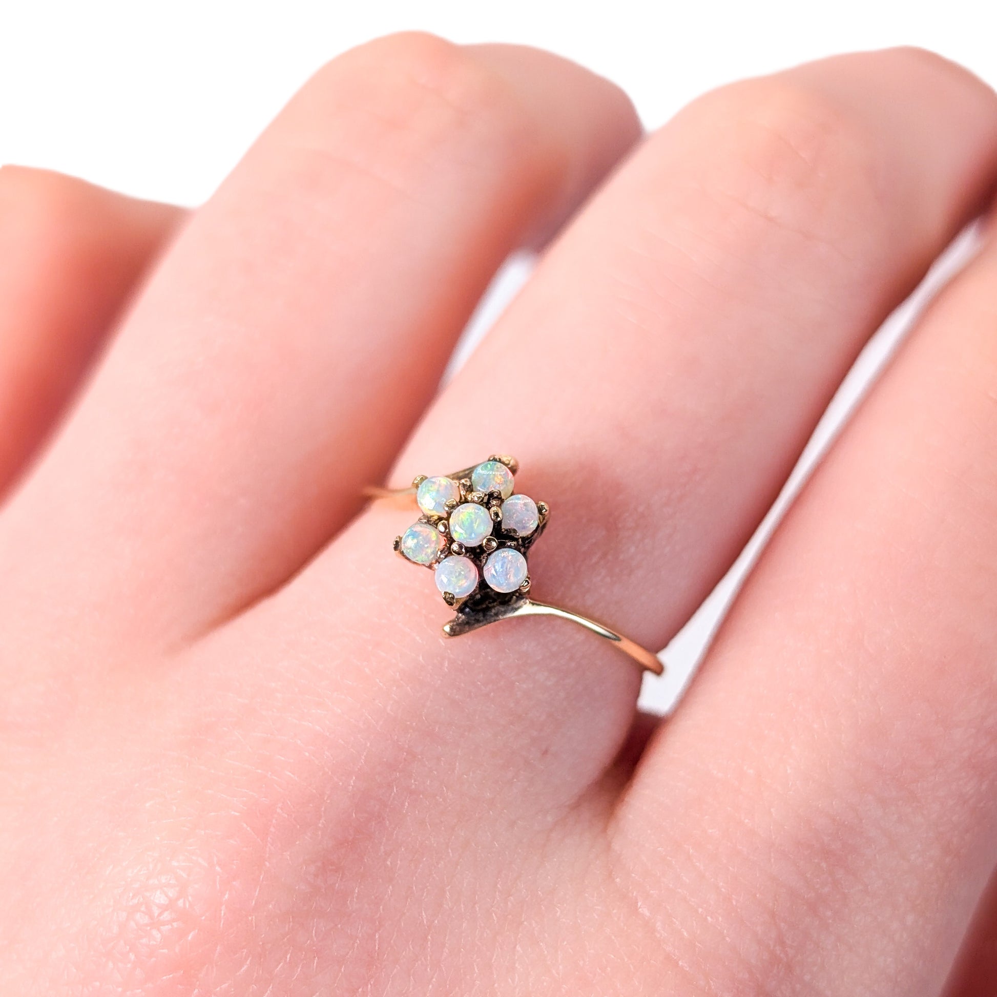 10K Gold ring with opal stones on a white background