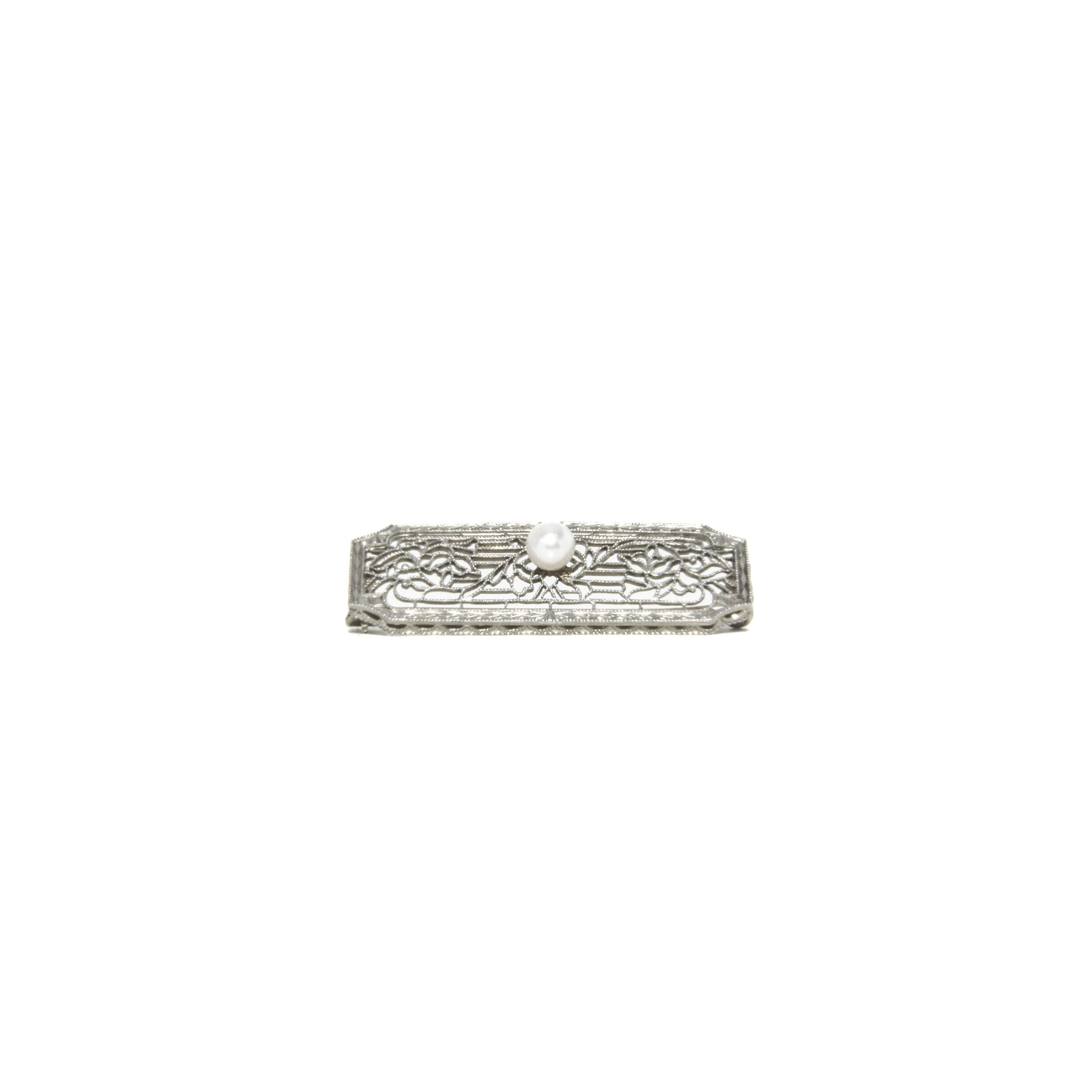 14k white gold art deco brooch with floral design on a white background