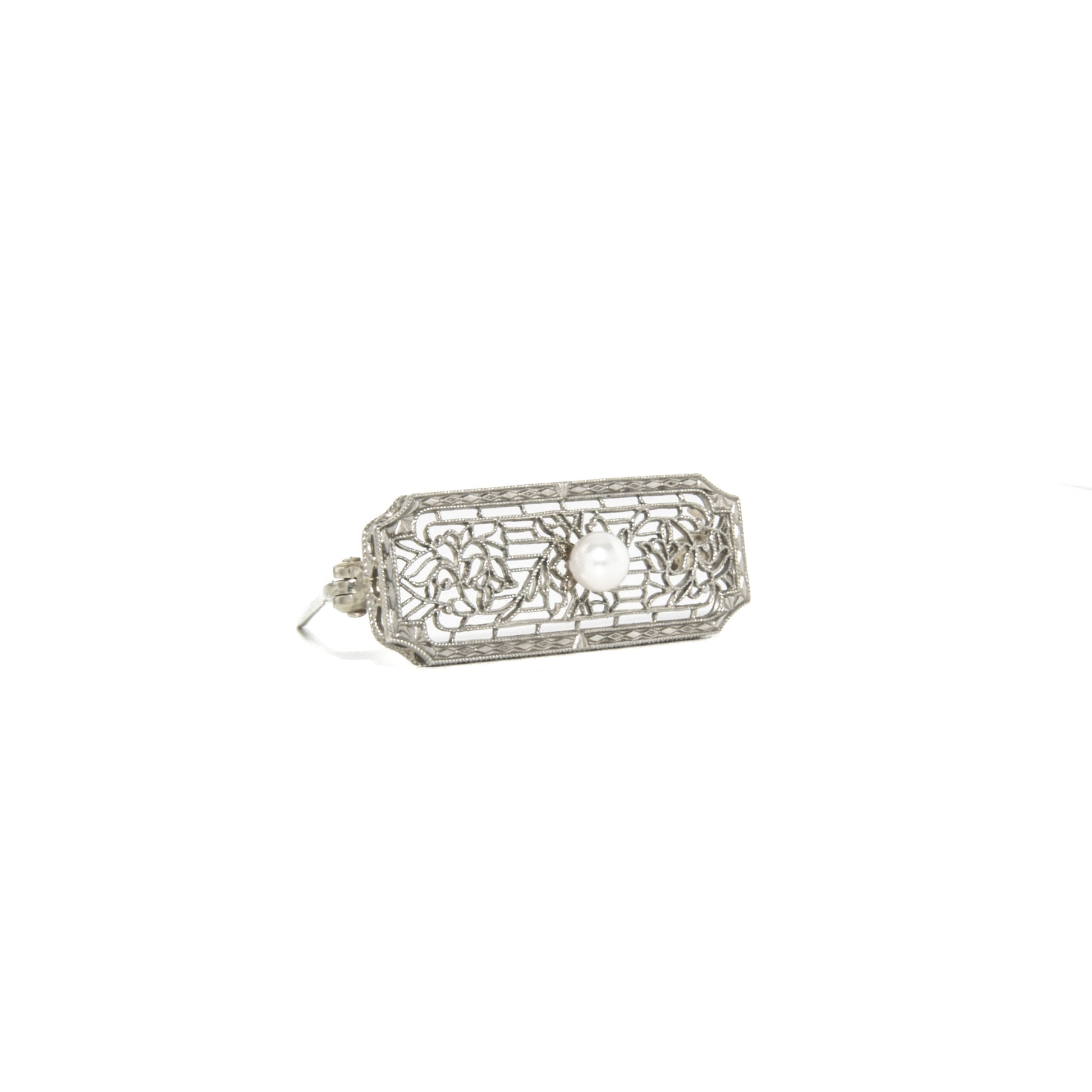 14k white gold art deco brooch with floral design on a white background