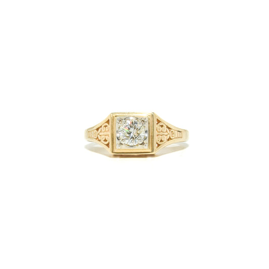 A vintage 14K gold diamond ring with ornate filigree work, featuring a round brilliant cut diamond set in a yellow gold mounting.