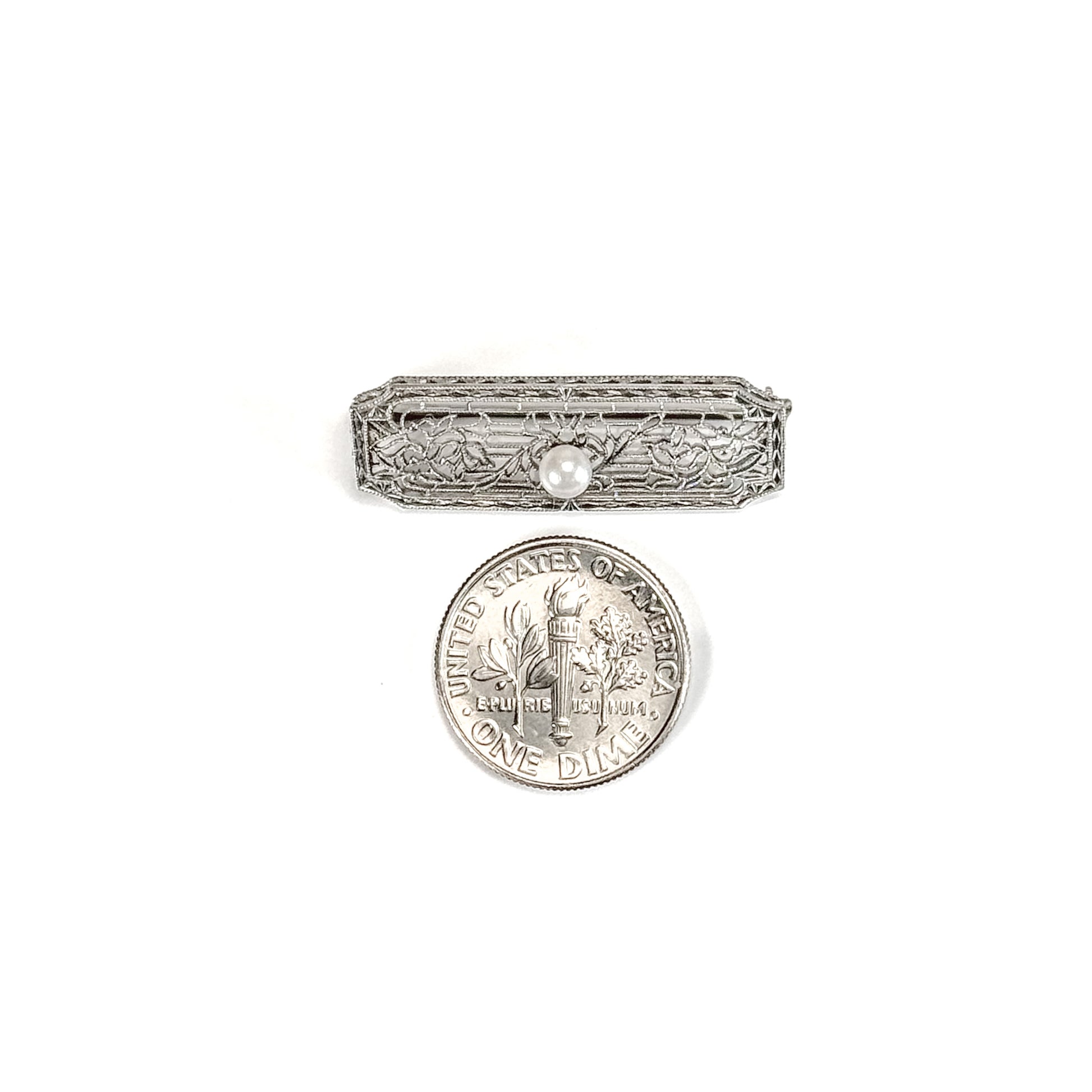14k white gold art deco brooch with floral design on a white background