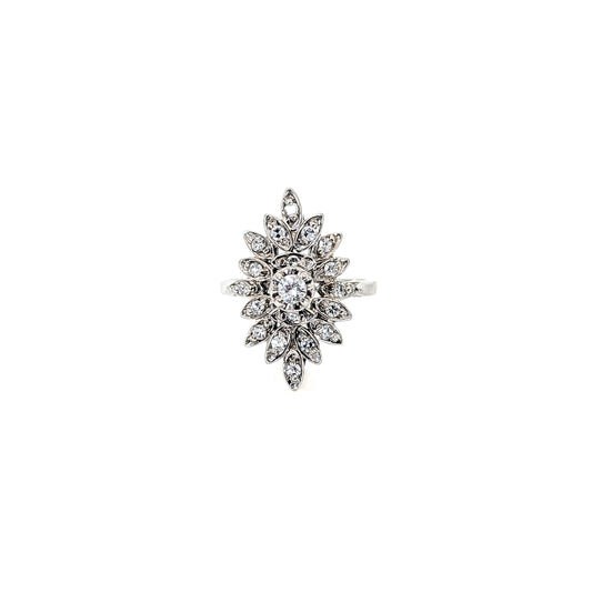 Luminous 14K white gold ring , the design features a brilliant round center diamond surrounded by an intricate halo of marquise-shaped with round diamond accents against a white background.