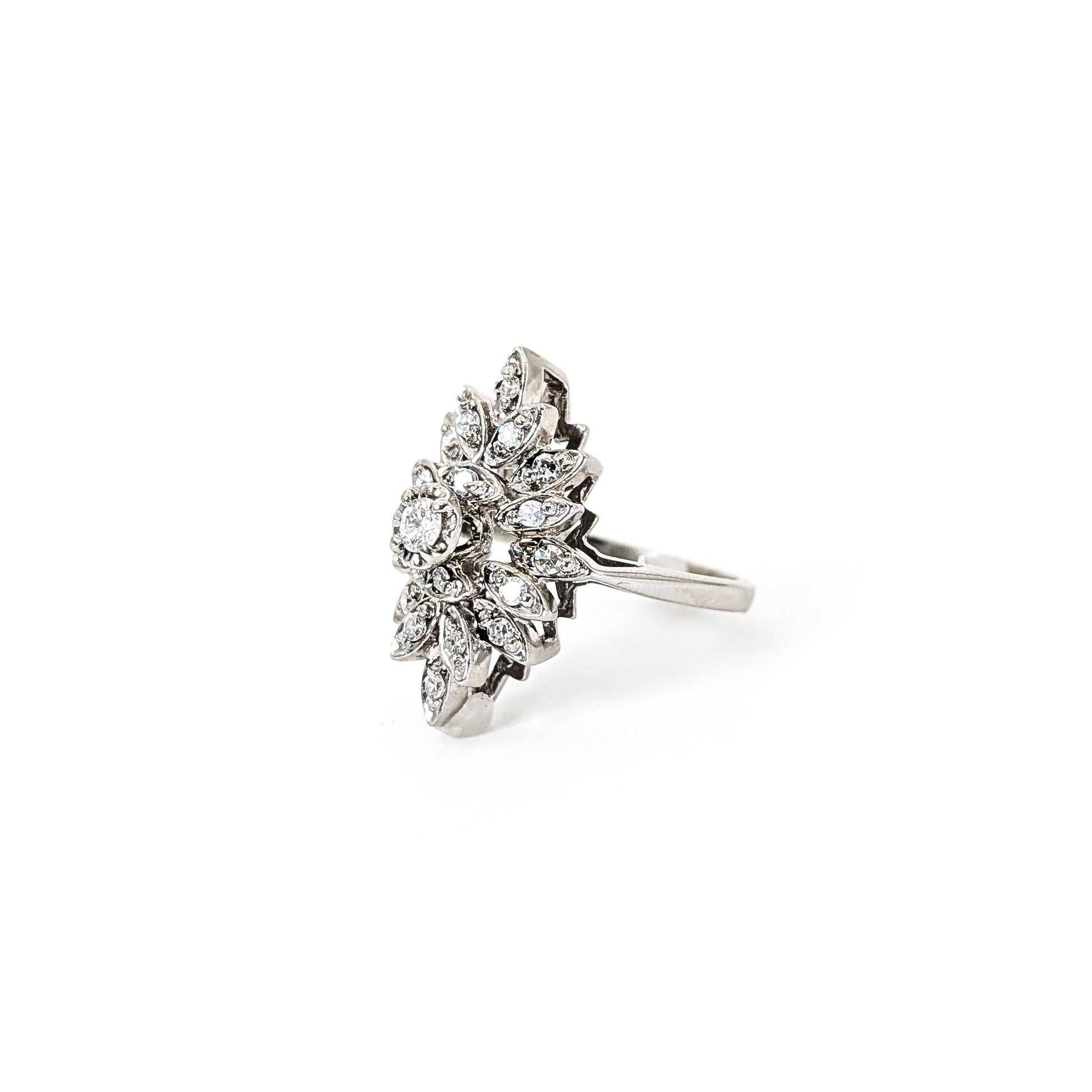 Luminous 14K white gold ring , the design features a brilliant round center diamond surrounded by an intricate halo of marquise-shaped with round diamond accents against a white background.