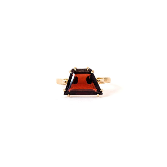 14K Gold garnet ring, cut into a striking trapezoid shape, on a white background