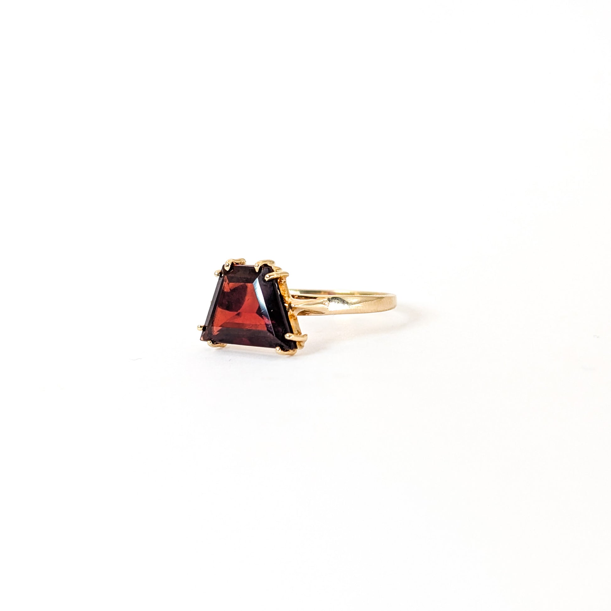 14K Gold garnet ring, cut into a striking trapezoid shape, on a white background