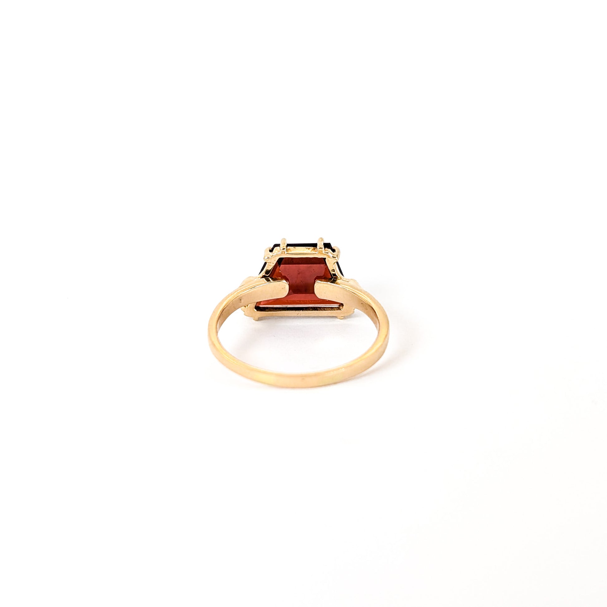 14K Gold garnet ring, cut into a striking trapezoid shape, on a white background