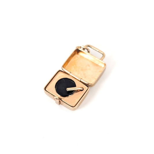 Vintage 14k gold mechanical charm is designed as a portable record player that closes into a travel case on a white background.