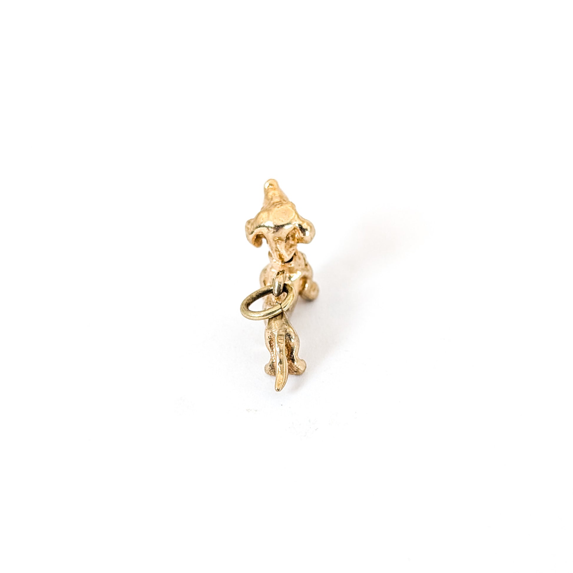 14K Gold dachshund mechanical charm on a white background