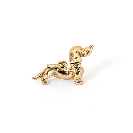14K Gold dachshund mechanical charm on a white background