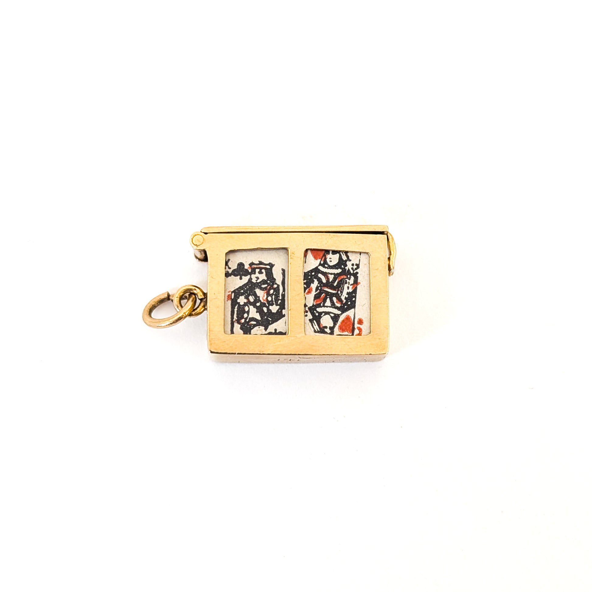 14k gold vintage mechanical charm with enameled card suit symbols and a real deck of cards on a white background