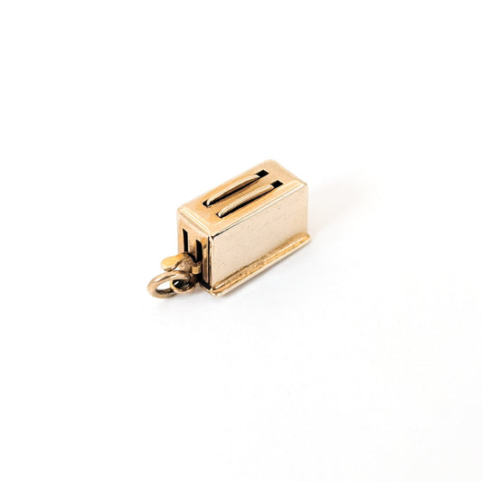 14k Gold toaster mechanical charm on a white background
