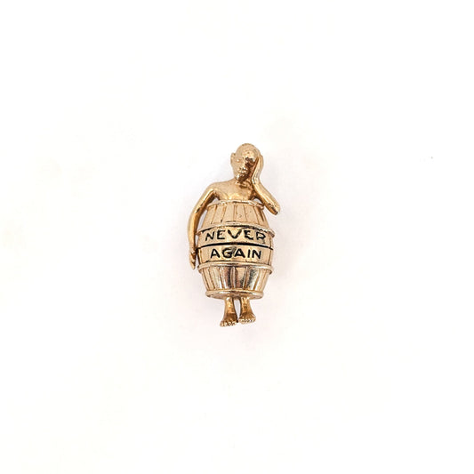 14K gold mechanical cram of a man in a barrel with 'Never Again' text on a white background