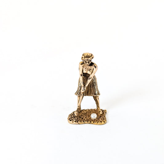 14k Gold vintage mechanical charm of lady playing golf with a pearl golf ball on a white background 