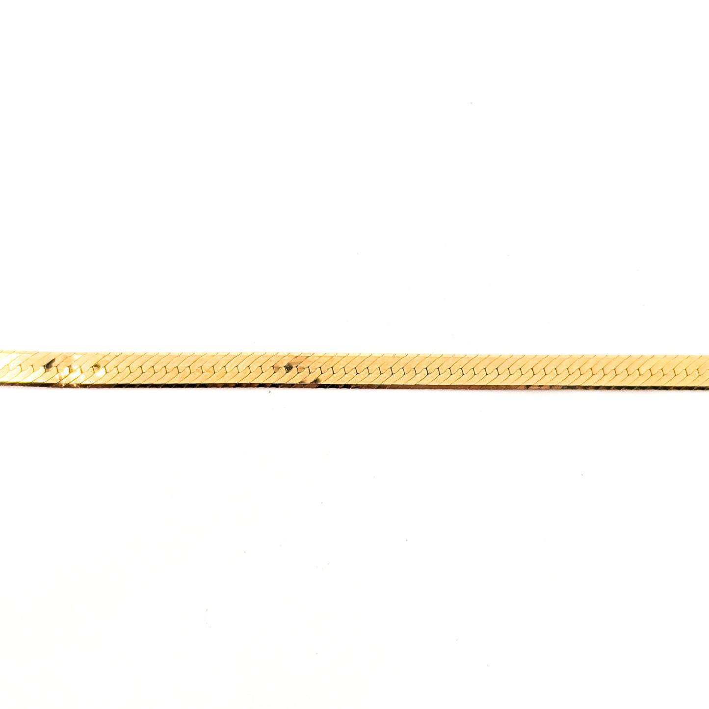 Vintage 14K gold bracelet features an elegant herringbone design with a textured finish  on a white background