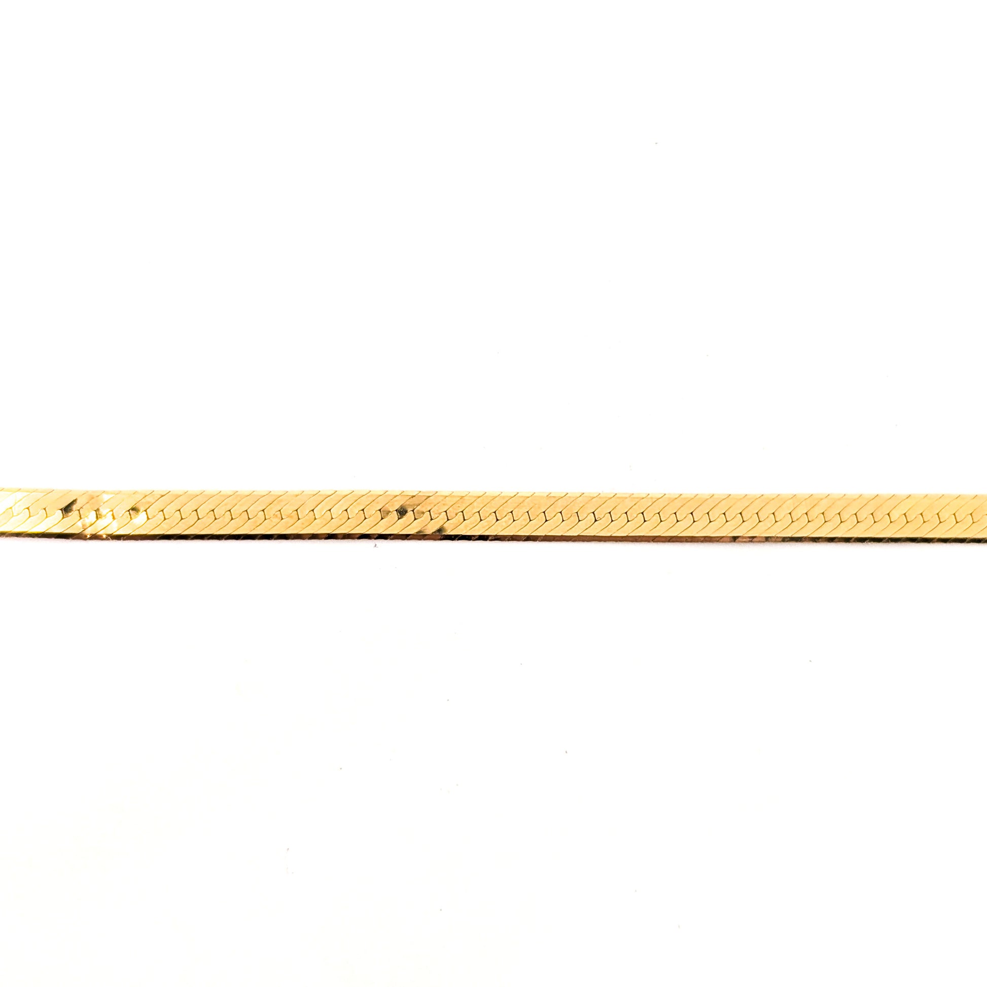 Vintage 14K gold bracelet features an elegant herringbone design with a textured finish  on a white background