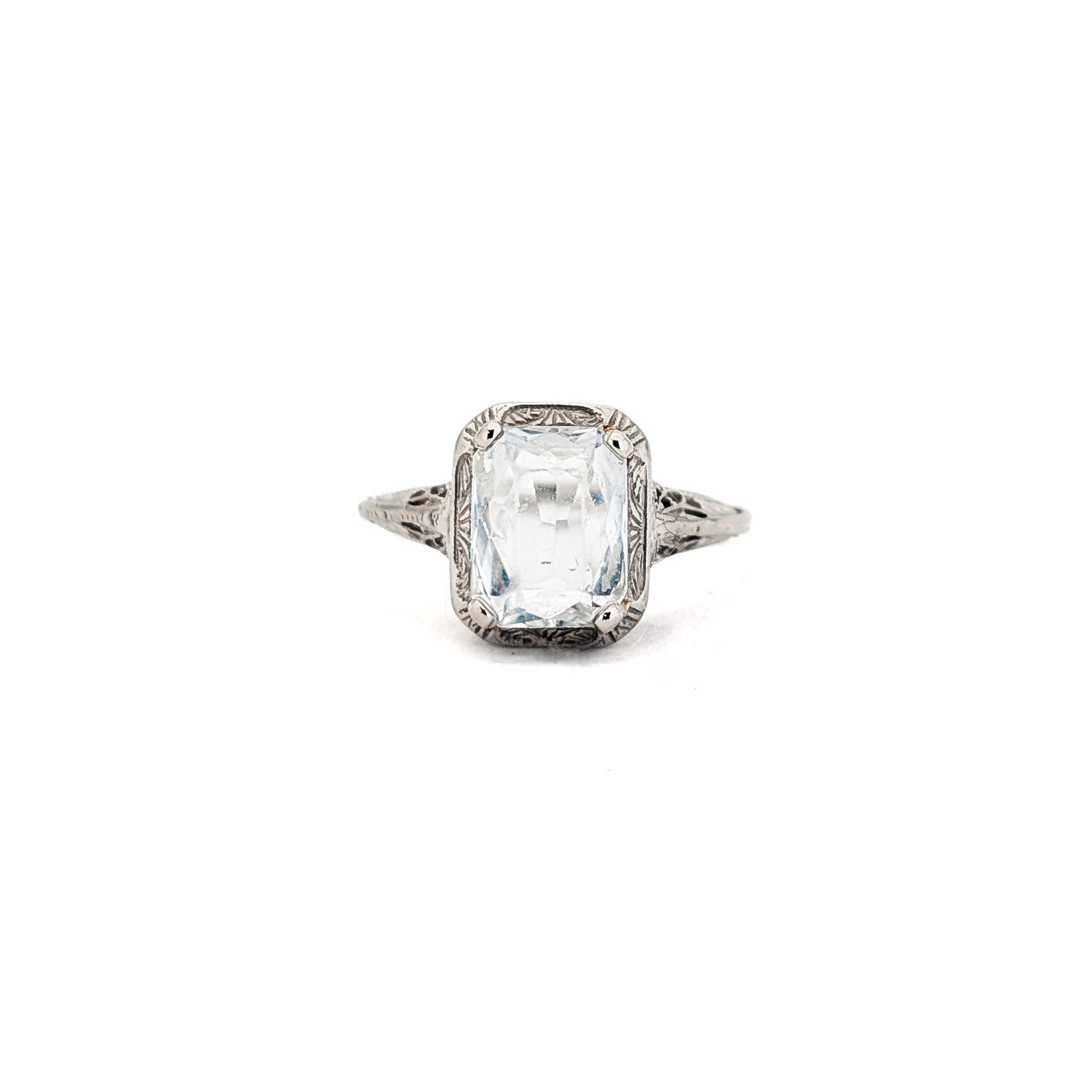 18k white gold ring with a rectangular aquamarine gemstone on a white background