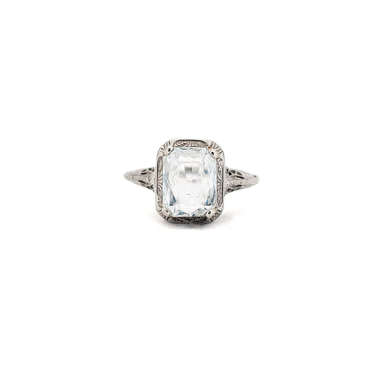 18k white gold ring with a rectangular aquamarine gemstone on a white background