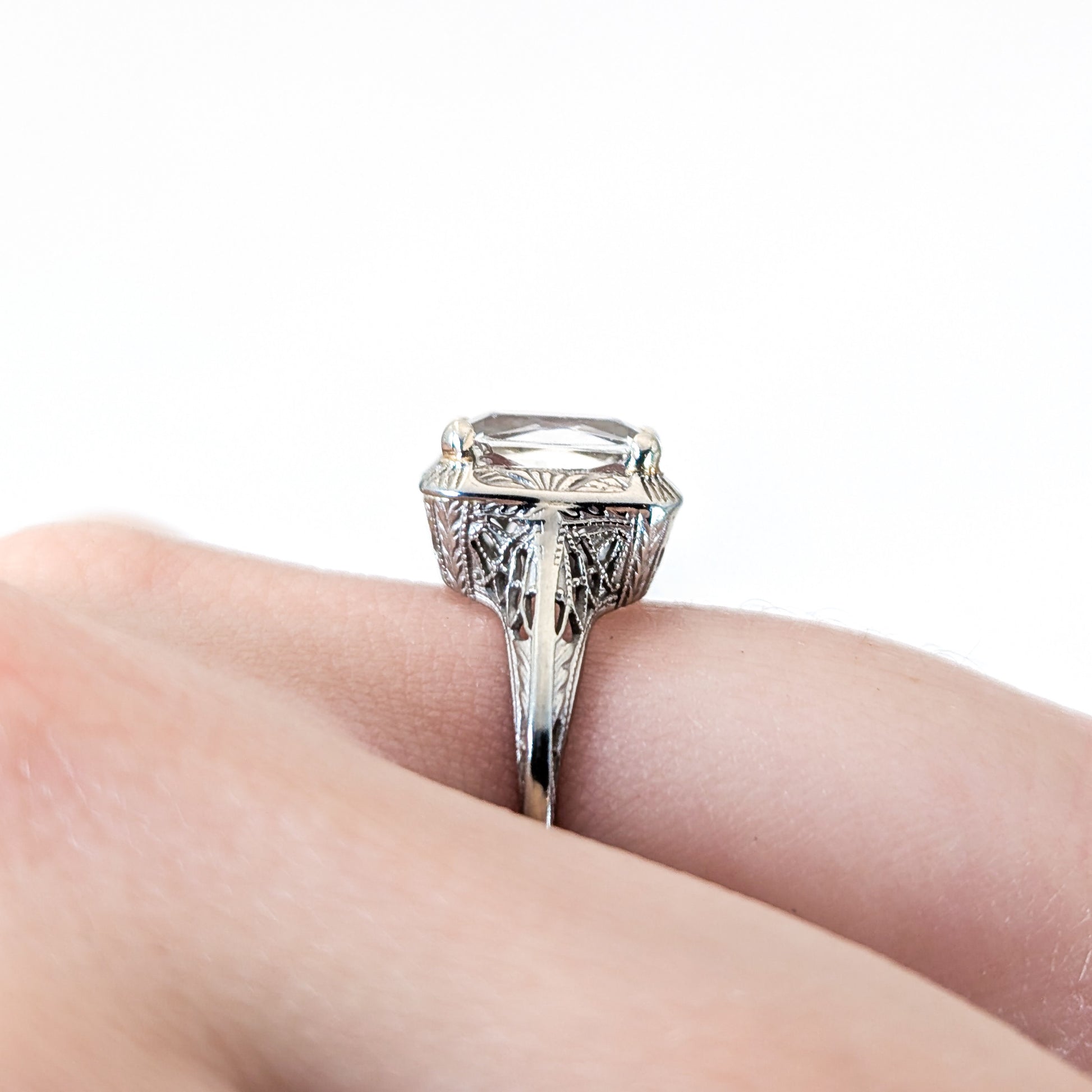 18k white gold ring with a rectangular aquamarine gemstone on a white background