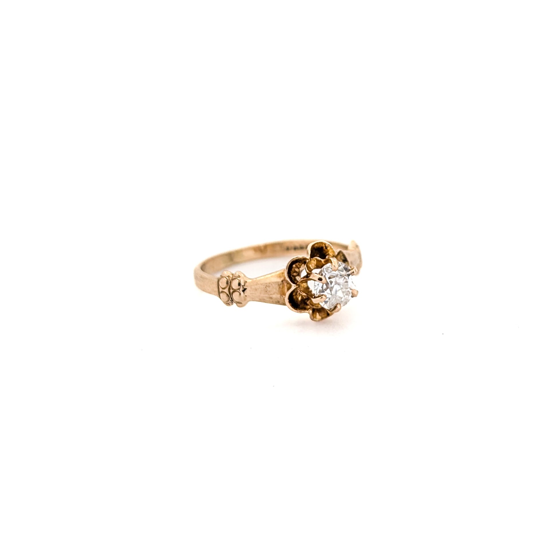 10k Gold ring with a diamond on a white background