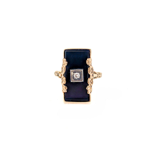 10K Gold Onyx ring with a central diamond on a white background