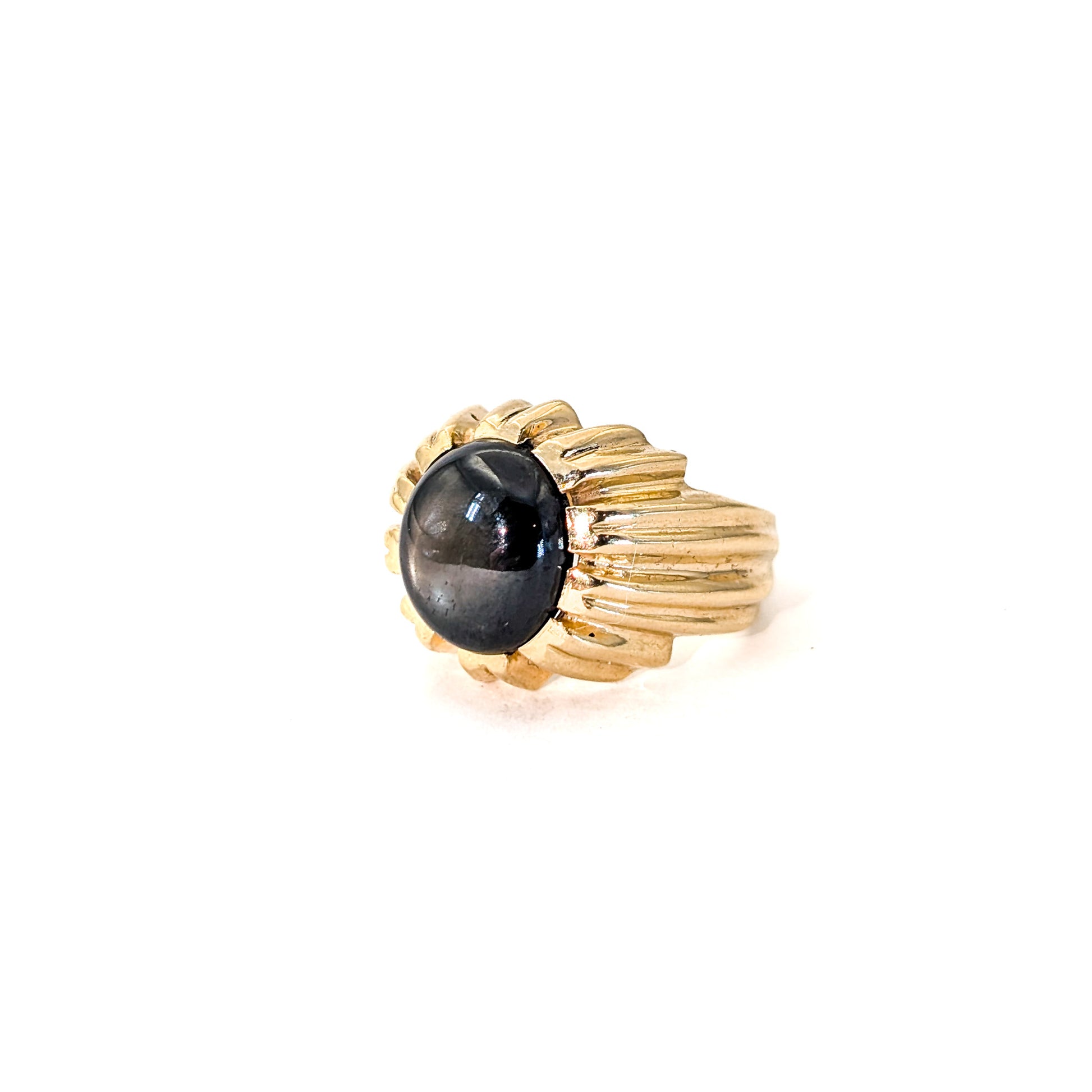 14K gold ring with a black star sapphire gemstone on a white background