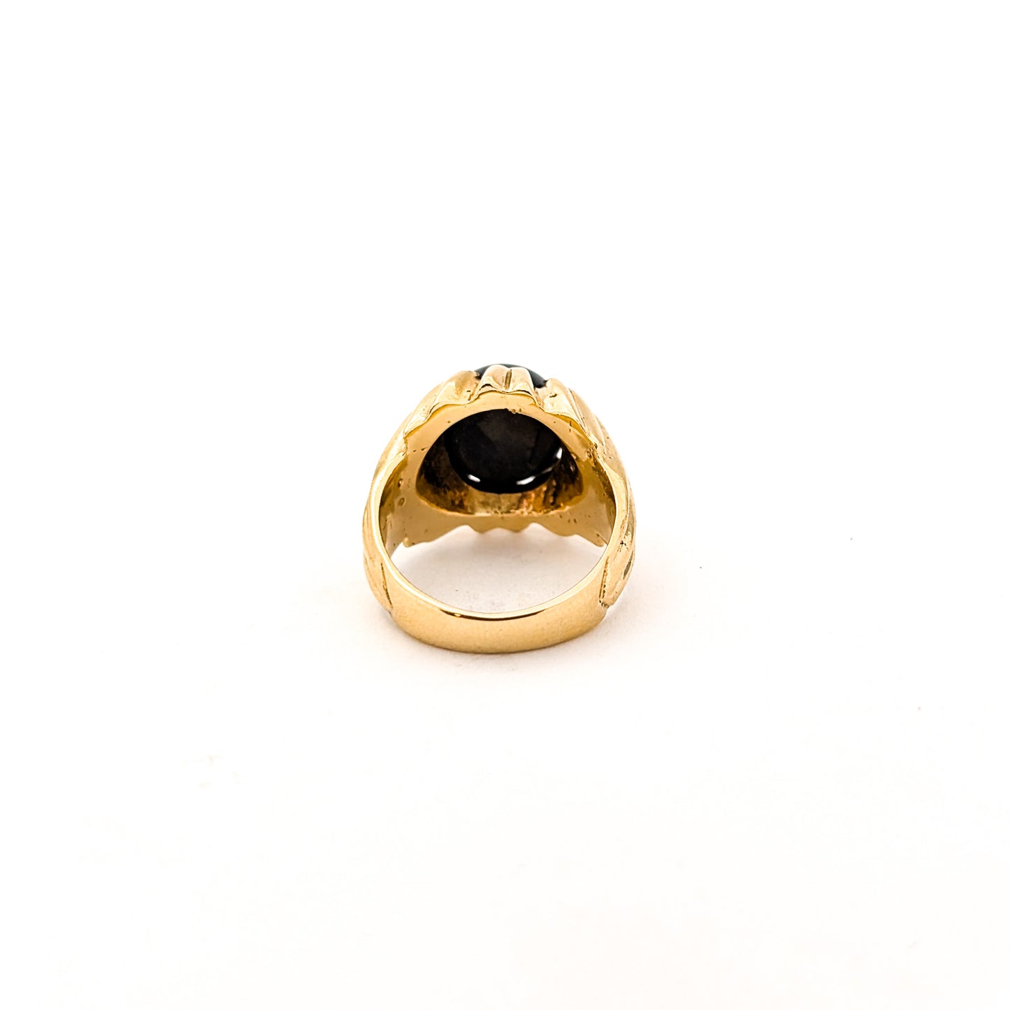 14K gold ring with a black star sapphire gemstone on a white background