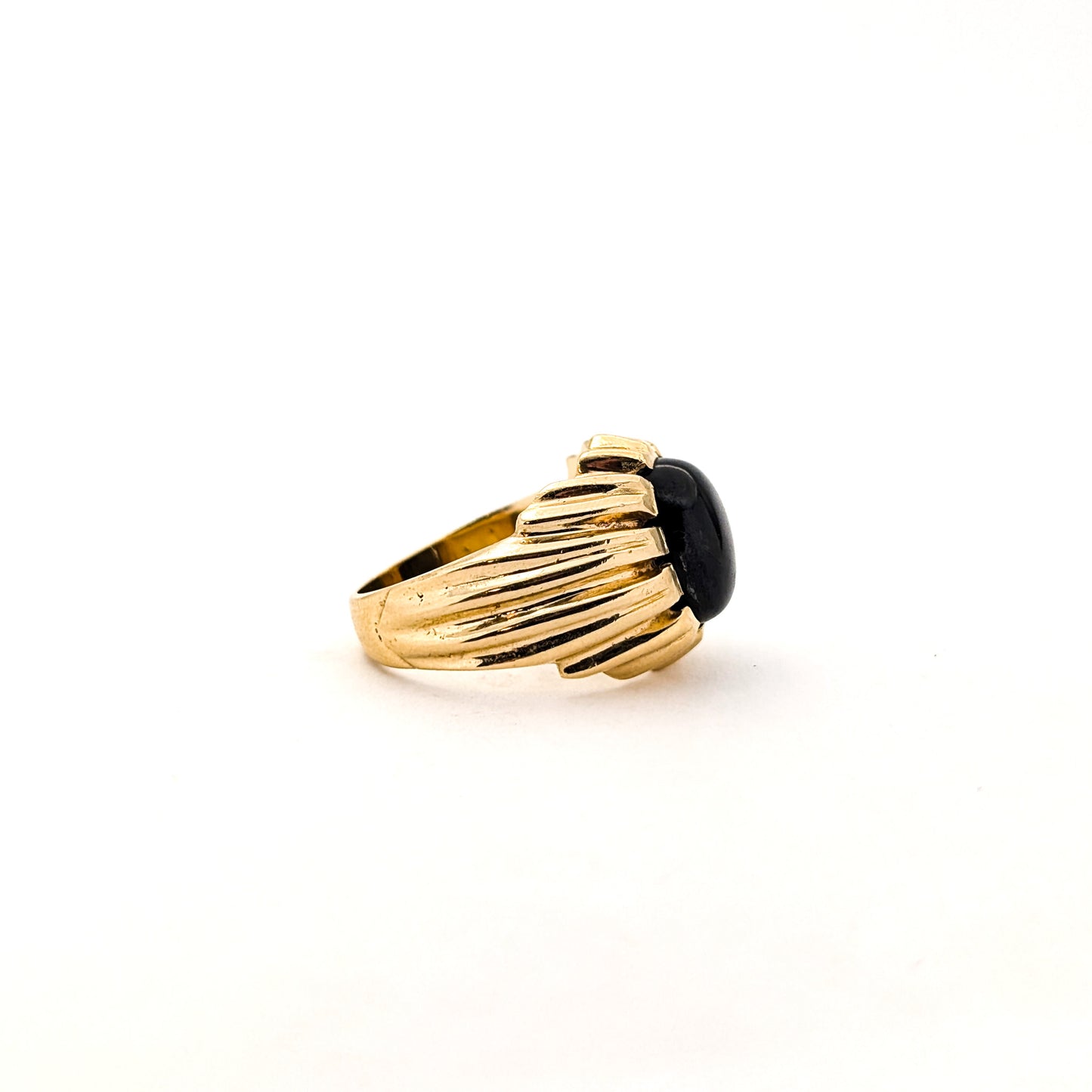 14K gold ring with a black star sapphire gemstone on a white background