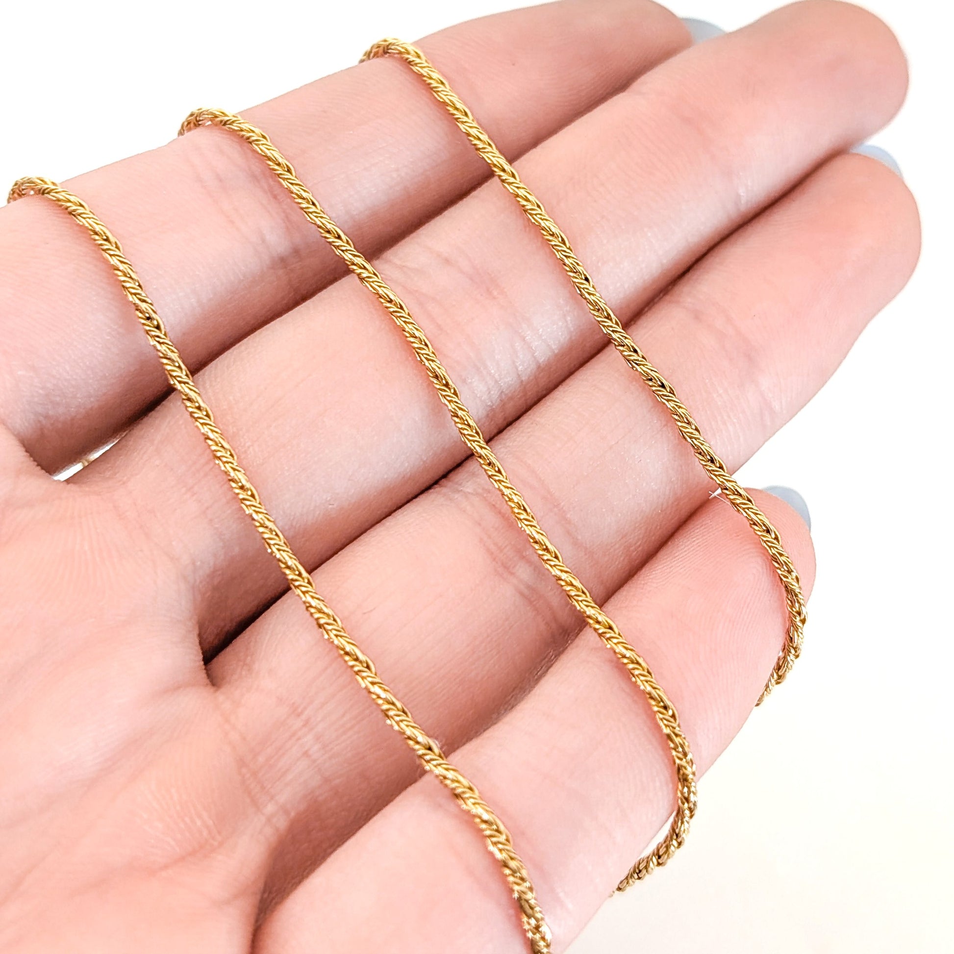 14K Gold chain necklace on a white background